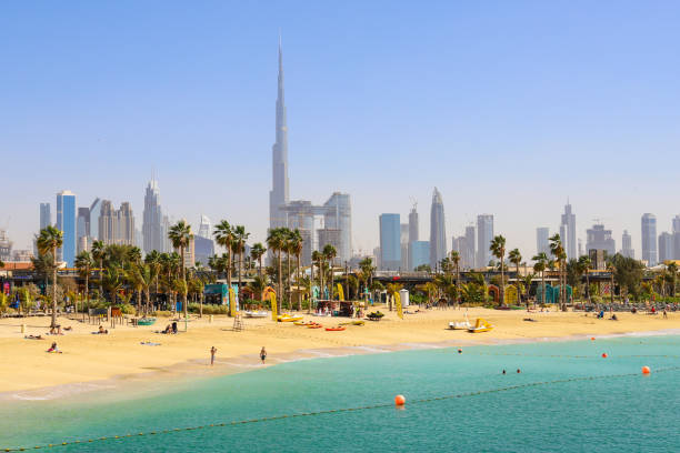 Dubai skyline with Burj Khalifa overlooking a beach, reflecting the vibrant business environment of IFZA Free Zone.